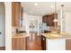Gourmet kitchen with dark wood cabinetry, stainless steel appliances, and a granite island at 1645 Renfroe Run, Cumming, GA 30041