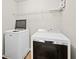 Clean laundry room featuring a newer washing machine and dryer, with storage shelf above at 1645 Renfroe Run, Cumming, GA 30041