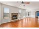 Spacious living room featuring hardwood floors, a stone fireplace, and stylish trim at 1645 Renfroe Run, Cumming, GA 30041