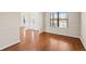 Inviting living room features beautiful hardwood floors and neutral paint, bathed in natural light at 1645 Renfroe Run, Cumming, GA 30041