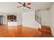 Bright living space with hardwood floors, staircase, and an open layout to the kitchen at 1645 Renfroe Run, Cumming, GA 30041