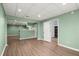 Open-concept basement with wood-look floors, neutral green walls, white ceilings, and recessed lights at 3655 Autumn Ridge Pkwy, Marietta, GA 30066