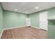 Basement area with light-green walls and vinyl floors, featuring a white refrigerator at 3655 Autumn Ridge Pkwy, Marietta, GA 30066