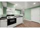 The basement includes a kitchen with black appliances, sink, and an opening to another room at 3655 Autumn Ridge Pkwy, Marietta, GA 30066