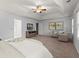 Spacious main bedroom with sitting area, and ceiling fan is bright from many windows at 3655 Autumn Ridge Pkwy, Marietta, GA 30066