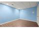 Finished room with light blue walls and wood-look flooring at 3655 Autumn Ridge Pkwy, Marietta, GA 30066
