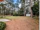 Backyard with mature trees, lawn, and storage shed at 4430 Locksley Rd, Tucker, GA 30084