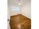 Bright bedroom with hardwood floors, a ceiling fan, and natural light from the window at 4430 Locksley Rd, Tucker, GA 30084