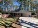 Beautiful brick home featuring a long driveway and a spacious carport at 4430 Locksley Rd, Tucker, GA 30084