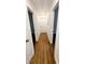 Hallway with hardwood flooring and white trim, and multiple doors at 4430 Locksley Rd, Tucker, GA 30084