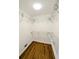 Walk-in closet with white shelving and hardwood floors at 4430 Locksley Rd, Tucker, GA 30084