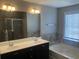 Elegant bathroom with double vanity, soaking tub, and tiled shower at 849 Arbor Crowne Dr, Lawrenceville, GA 30045