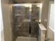 Modern bathroom featuring a glass-enclosed shower with tile surround at 849 Arbor Crowne Dr, Lawrenceville, GA 30045