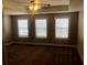 Spacious primary bedroom with tray ceiling and natural light at 849 Arbor Crowne Dr, Lawrenceville, GA 30045