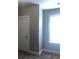 A bright room is shown featuring a window and white painted door at 849 Arbor Crowne Dr, Lawrenceville, GA 30045