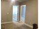 A carpeted hallway leads to a doorway and a room in this neutral-toned home interior at 849 Arbor Crowne Dr, Lawrenceville, GA 30045
