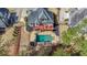 An aerial view highlights a backyard pool and wooden deck of a house and surrounding yards with mature trees at 151 Creek Bank Dr, Acworth, GA 30101