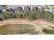 An aerial view shows homes lining a golf course and street with manicured lawns and mature landscaping at 151 Creek Bank Dr, Acworth, GA 30101