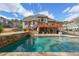 The in-ground pool with stone accents and a covered patio are great for outdoor entertaining at 151 Creek Bank Dr, Acworth, GA 30101