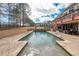 The backyard pool features stone accents and is perfect for cooling off on hot summer days at 151 Creek Bank Dr, Acworth, GA 30101