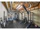 A finished basement features a home gym complete with weight rack, workout bench, and mirrors at 151 Creek Bank Dr, Acworth, GA 30101