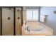 Bathroom featuring a jetted tub, enclosed shower, and shuttered window at 151 Creek Bank Dr, Acworth, GA 30101