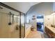 Bright bathroom featuring a glass-enclosed shower, jetted tub, and warm tile flooring at 151 Creek Bank Dr, Acworth, GA 30101