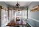 Breakfast nook with wooden table, white shutters and a view to the backyard at 151 Creek Bank Dr, Acworth, GA 30101