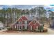 Charming two-story brick home with a well-manicured lawn and mature trees providing a private, serene setting at 151 Creek Bank Dr, Acworth, GA 30101