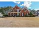 Charming two-story brick home with a well-manicured lawn and mature trees providing a private, serene setting at 151 Creek Bank Dr, Acworth, GA 30101