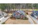 Beautiful aerial view of a brick two-story home in a well-maintained neighborhood with long driveway at 151 Creek Bank Dr, Acworth, GA 30101