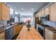 Bright kitchen features an island, stainless steel appliances, and access to living room at 151 Creek Bank Dr, Acworth, GA 30101