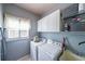 Well-organized laundry room with modern appliances, ample cabinet space, and a bright window at 151 Creek Bank Dr, Acworth, GA 30101
