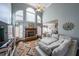 Comfortable living room features fireplace, large windows, and cozy seating arrangement at 151 Creek Bank Dr, Acworth, GA 30101