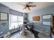 Bright home office featuring a ceiling fan, large windows, and a cozy round rug on wood flooring at 151 Creek Bank Dr, Acworth, GA 30101