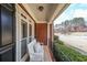 Inviting front porch features a charming white bench and offers a welcoming view of the neighborhood at 151 Creek Bank Dr, Acworth, GA 30101