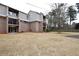 Backyard featuring grass, trees, and apartments with balconies at 3301 Henderson Mill Rd # F1, Atlanta, GA 30341