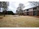 Exterior shot of backyard with grass, trees, and buildings with balconies at 3301 Henderson Mill Rd # F1, Atlanta, GA 30341