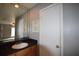 Bathroom vanity with a sink, a black countertop, and a mirror and a view of the bedroom at 3301 Henderson Mill Rd # F1, Atlanta, GA 30341