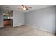 Spacious bedroom with a ceiling fan and access to the ensuite bathroom with carpet floors at 3301 Henderson Mill Rd # F1, Atlanta, GA 30341