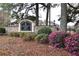 Elegant community sign set amidst lush landscaping and flowering shrubs, indicating a private neighborhood at 3301 Henderson Mill Rd # F1, Atlanta, GA 30341