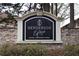 Henderson Park community sign surrounded by greenery and stone walls at 3301 Henderson Mill Rd # F1, Atlanta, GA 30341