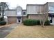 Attractive townhome with brick and stucco exterior, neat landscaping, walkway leading to the front door offer curb appeal at 3301 Henderson Mill Rd # F1, Atlanta, GA 30341