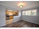 Kitchen featuring stainless steel appliances, tile floors, wooden cabinets, black countertops, and an opening to living area at 3301 Henderson Mill Rd # F1, Atlanta, GA 30341