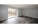 This living room features gray paint, wood-look flooring, a large sliding glass door and access to the outside balcony at 3301 Henderson Mill Rd # F1, Atlanta, GA 30341