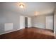 Open living room featuring hardwood floors and three access doors at 3301 Henderson Mill Rd # F1, Atlanta, GA 30341