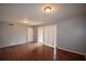 Open living room with hardwood floors, sliding door and a hallway door at 3301 Henderson Mill Rd # F1, Atlanta, GA 30341