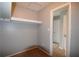 Walk-in closet with neutral paint and carpet and white shelving for storage space at 3301 Henderson Mill Rd # F1, Atlanta, GA 30341