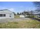 Backyard features a concrete patio, additional storage, and mature trees at 5205 Dunmoreland Ct, Atlanta, GA 30349