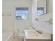 Traditional bathroom with white tile, a large mirror, and plenty of natural light at 5205 Dunmoreland Ct, Atlanta, GA 30349